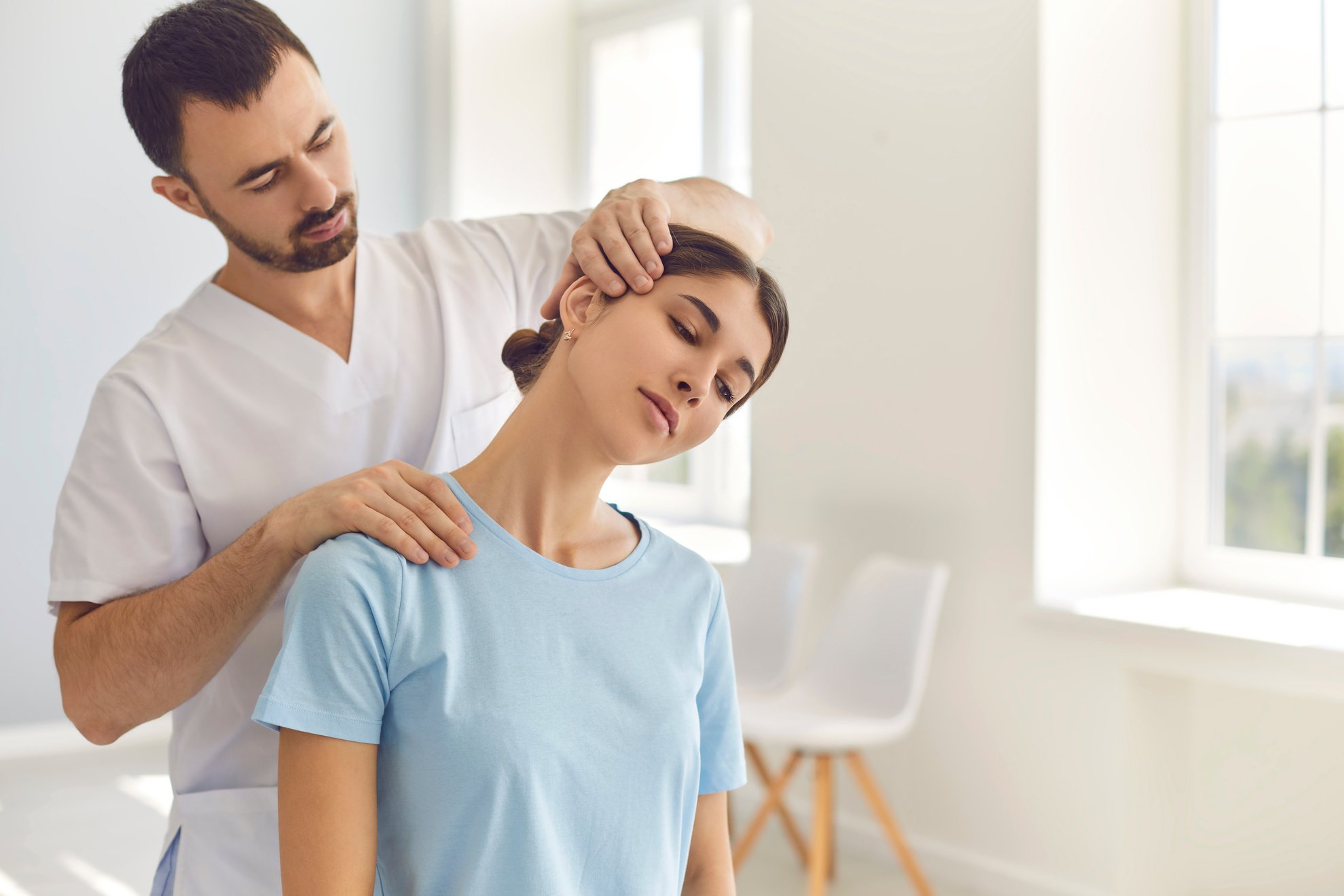 Professional Osteopath during Work Fixing Womans Neck